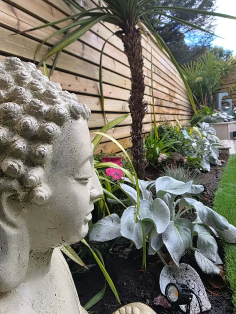 Planting scheme with slatted fence and garden lighting by RS Bespoke Gardens